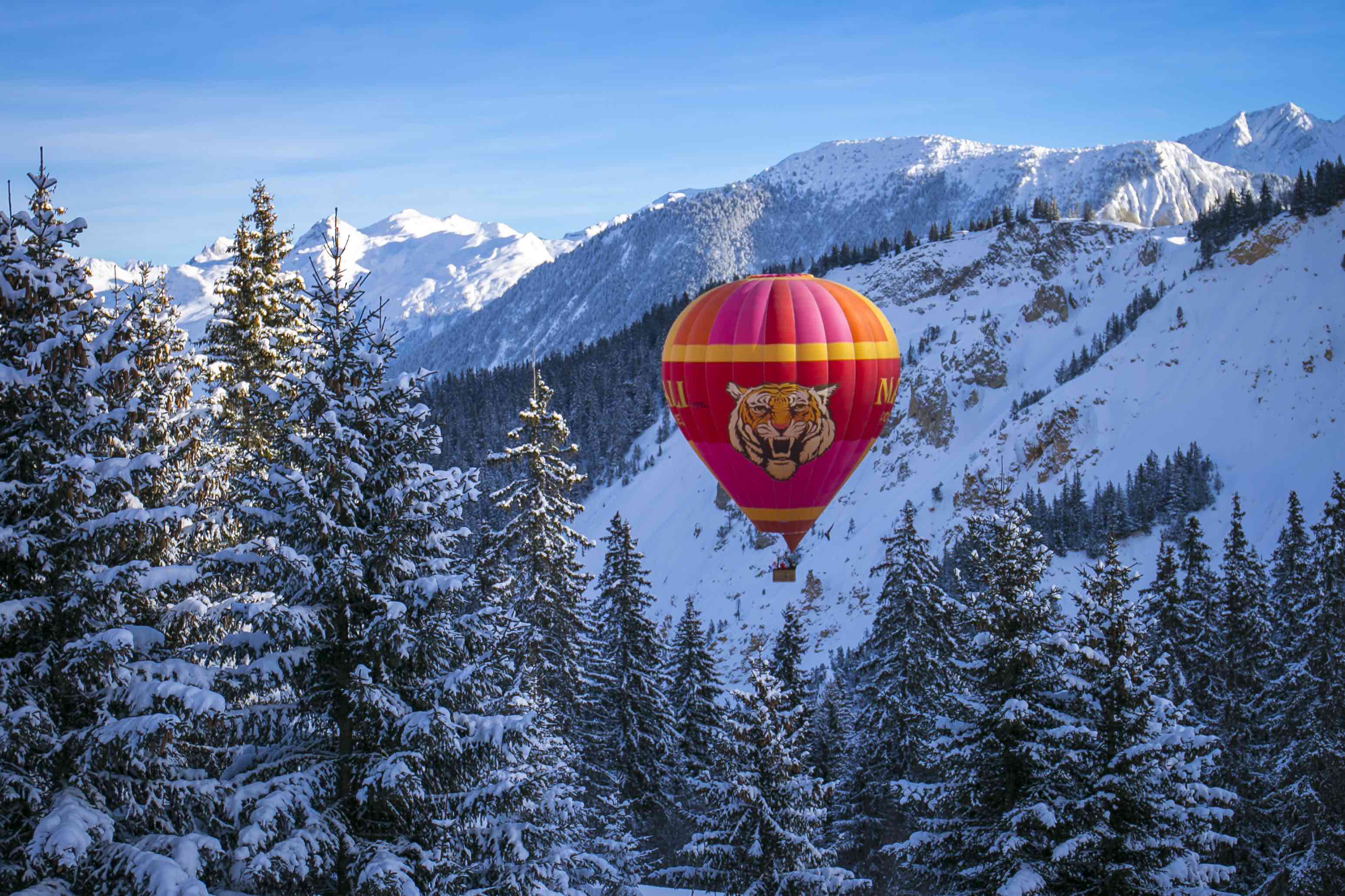 Hot-air balloon above snowy Courchevel