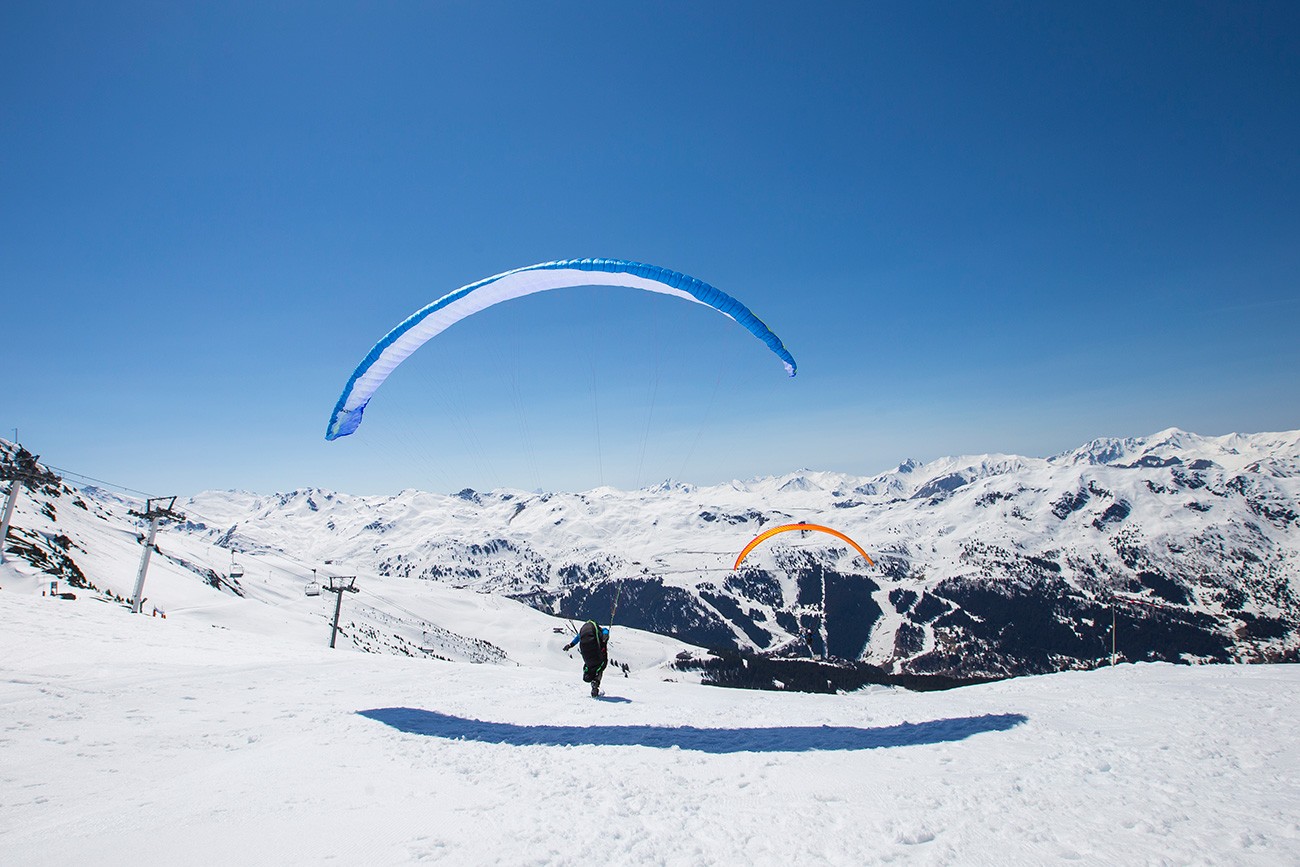 Paragliding above the snowy valleys