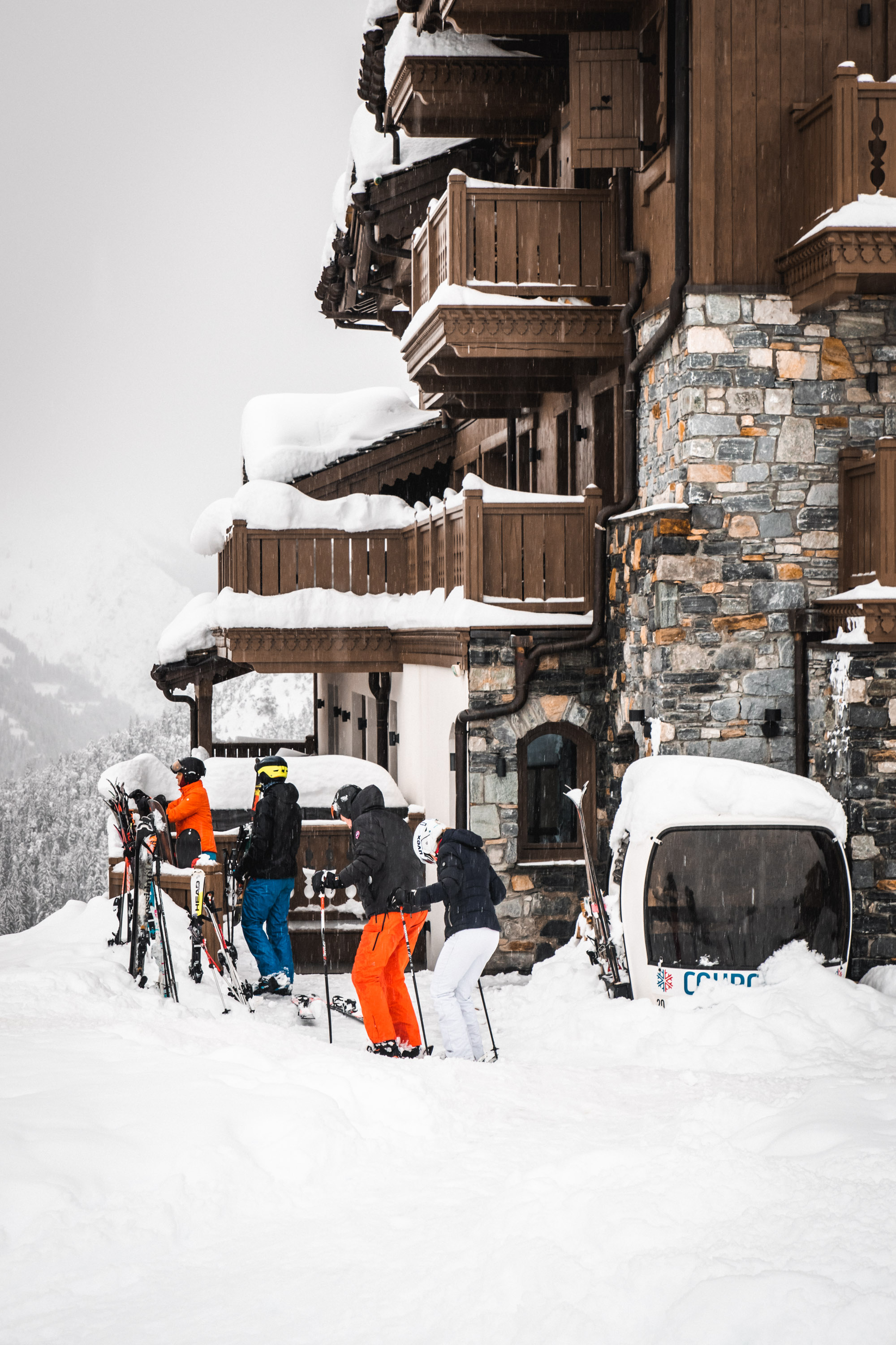 Skiers in front of the snow-covered Manali Lodge hotel