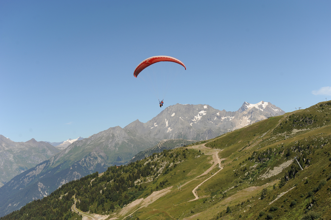 Paragliding above the valleys in summer